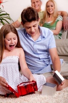 http://www.freedigitalphotos.net/images/Family_g212-Kids_Opening_Christmas_Gifts_With_Parents_In_The_Background_p34458.html