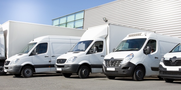 Delivery-white-vans-service-van-trucks-cars-front-entrance-warehouse-distribution-logistic-society.jpg
